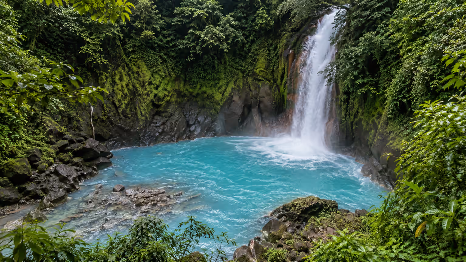 Rio Celeste waterfall surrounded by tropical forest in Costa Rica