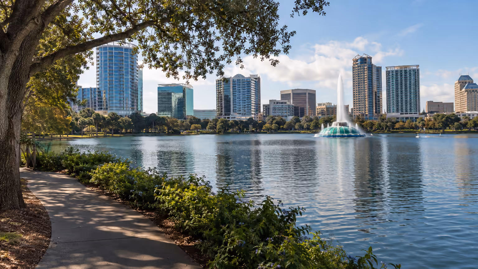 Lake Eola in downtown Orlando Florida with its fountain and low city skyline beyond a natural