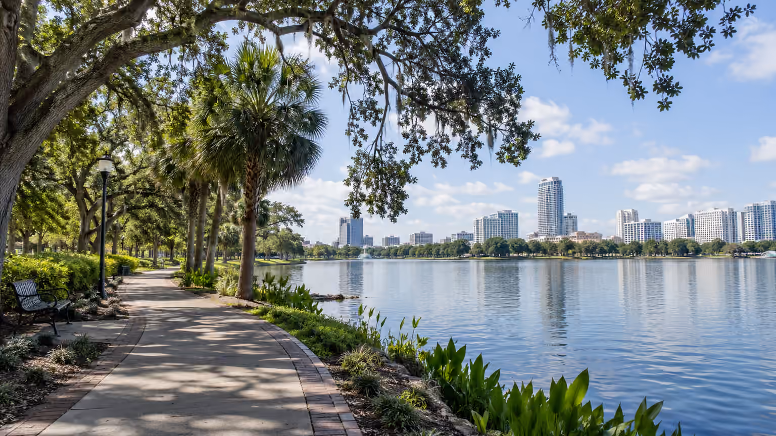 An Orlando public lakeside park path with shade trees